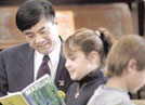 Governor Locke reads with a student