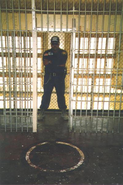 Guard in front of painted pentagram, 1985-2008, Department of Corrections, McNeil Island Corrections Center Photograph Collection, 1855-2010, Digital Archives.